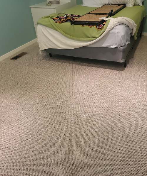 A bedroom with a bed and a nightstand
