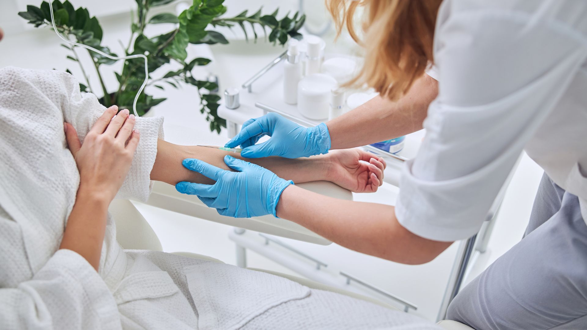 Medical professional preparing to draw blood from patient's arm